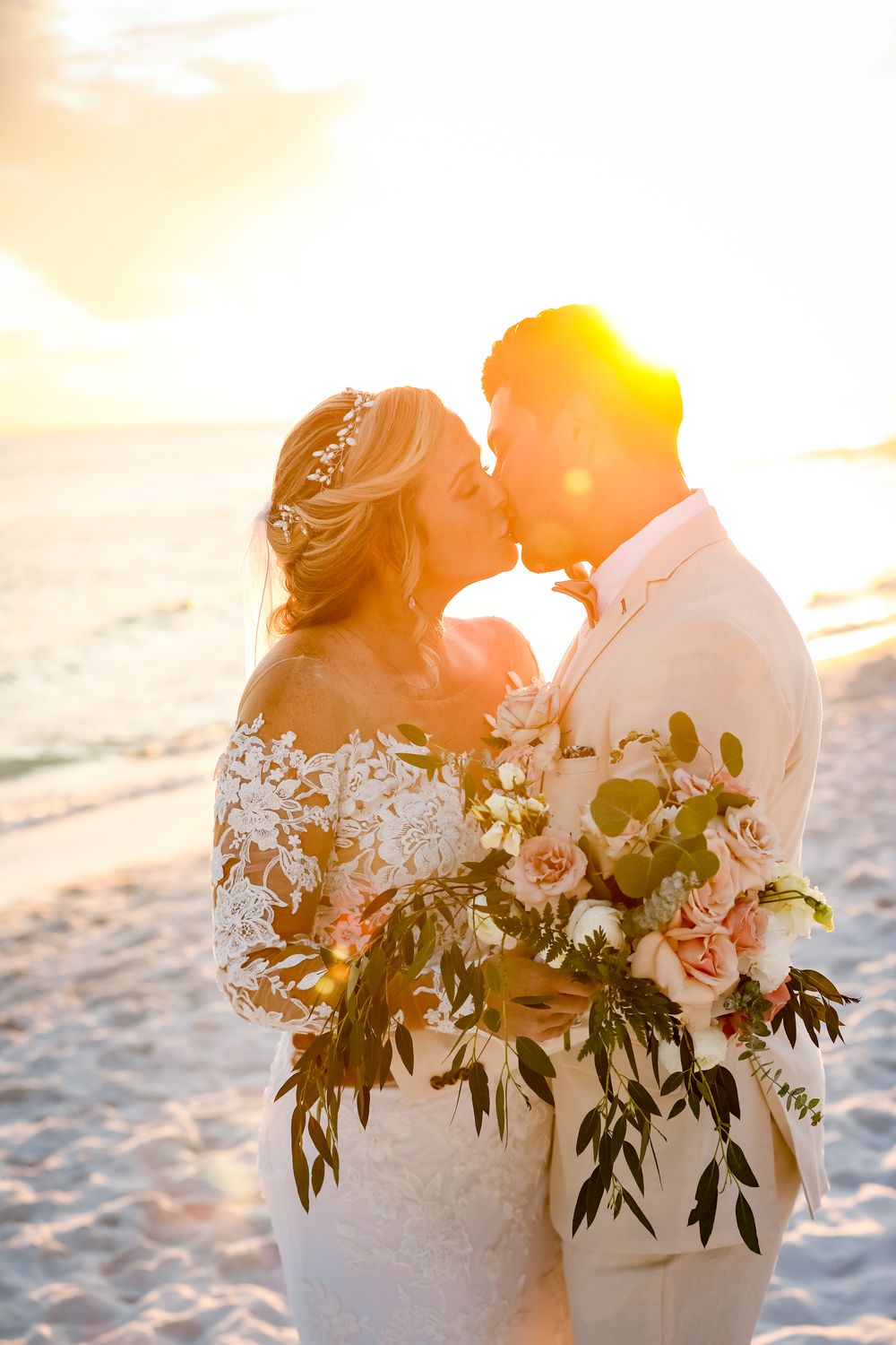 Married couple kissing on beach with bouquet sunset Destin by Jay Grubb Photography