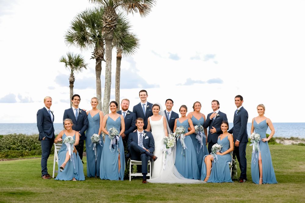 couple posing with Bridal party group shot on green grass lawn by Jay Grubb Photography