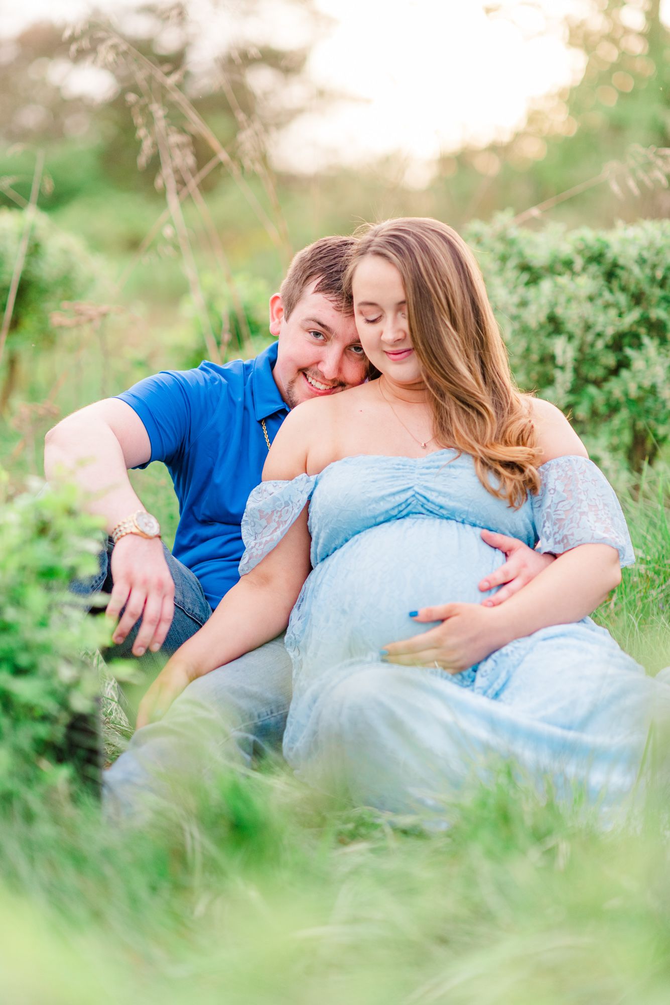 Maternity session with couple in field in golden hour sunlight at Moraine State Park, Pennsylvania