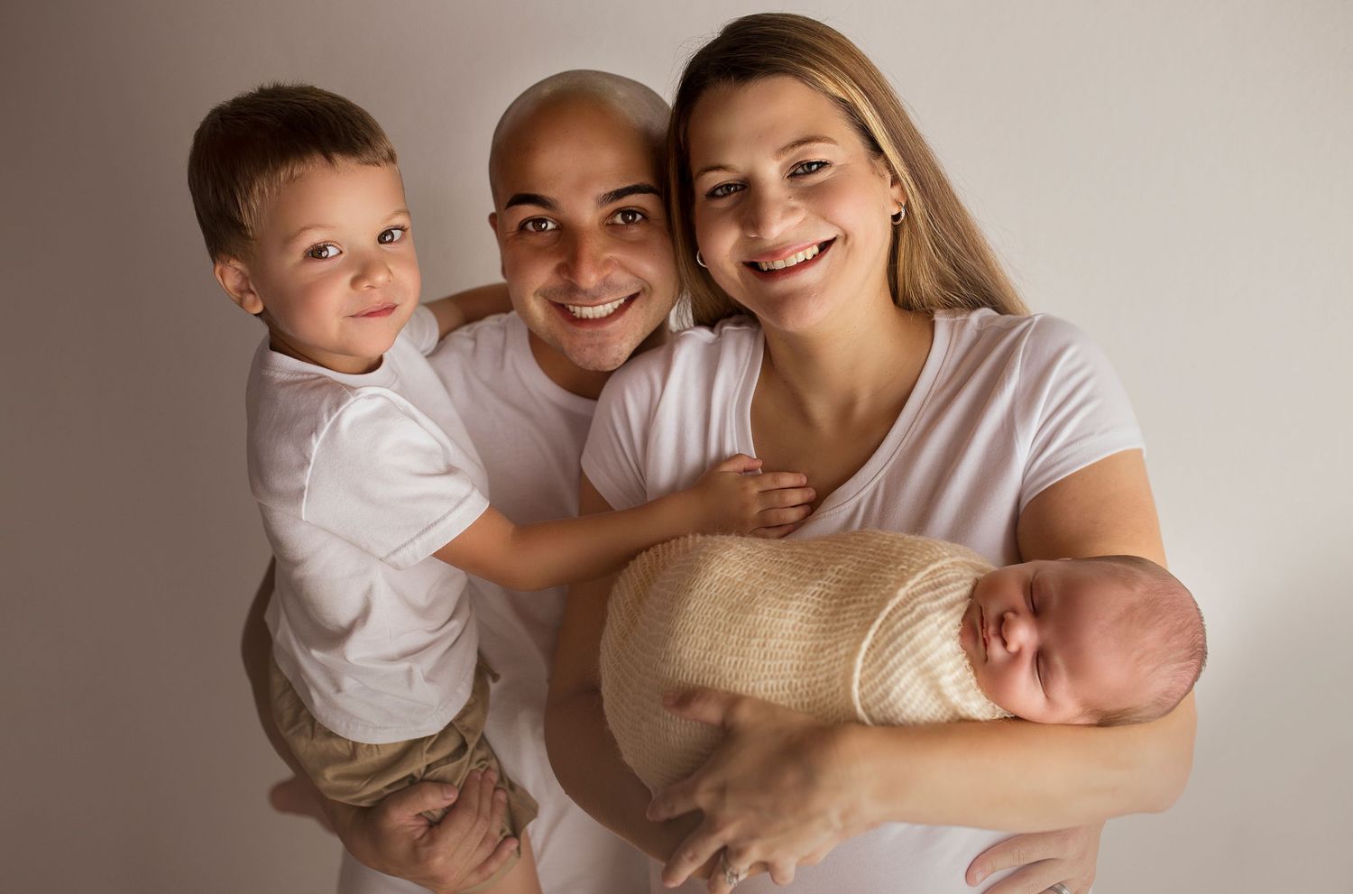 family of four holing new child