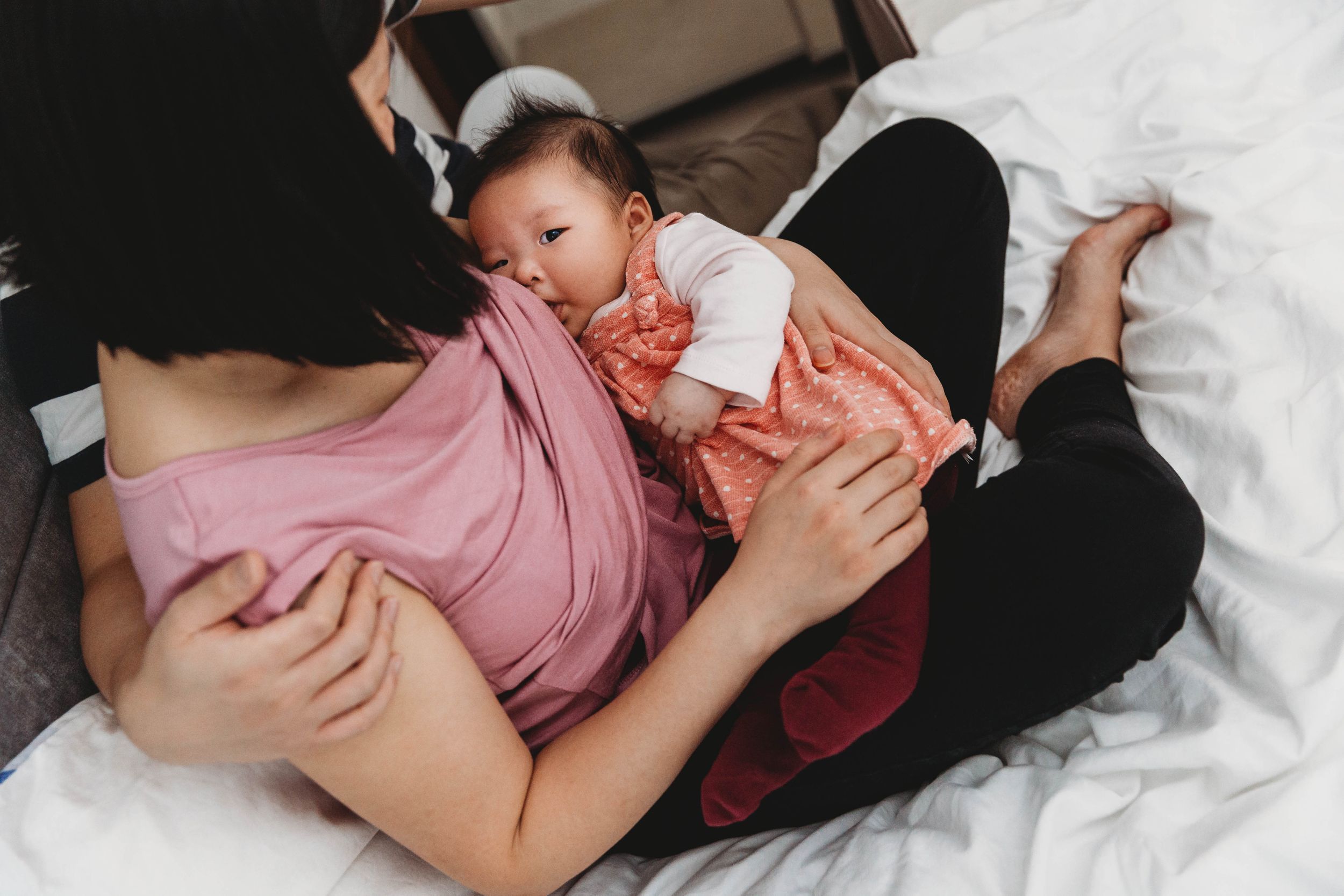 breastfeeding baby looking at camera