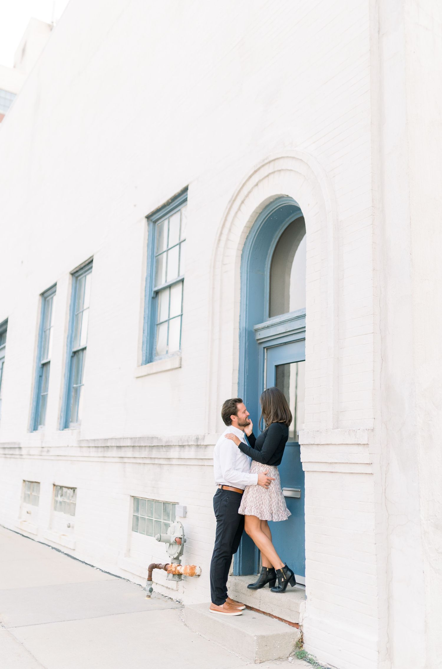 Des Moines Engagement photos in downtown Des Moines, Iowa with light and airy photographer Nicole Laing
