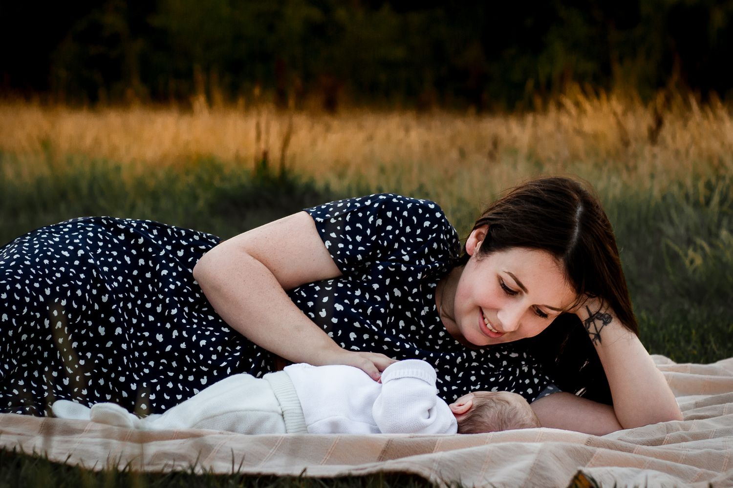 In a field in Havant a new Mum lays beside her newborn Son smiling.