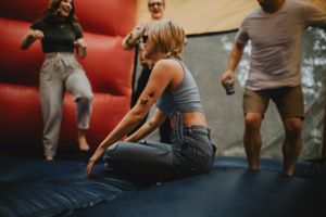 a girl sitting on the floor of a bounce house
