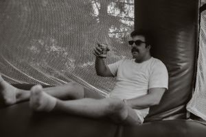 a gentleman sitting on the floor of a bounce house