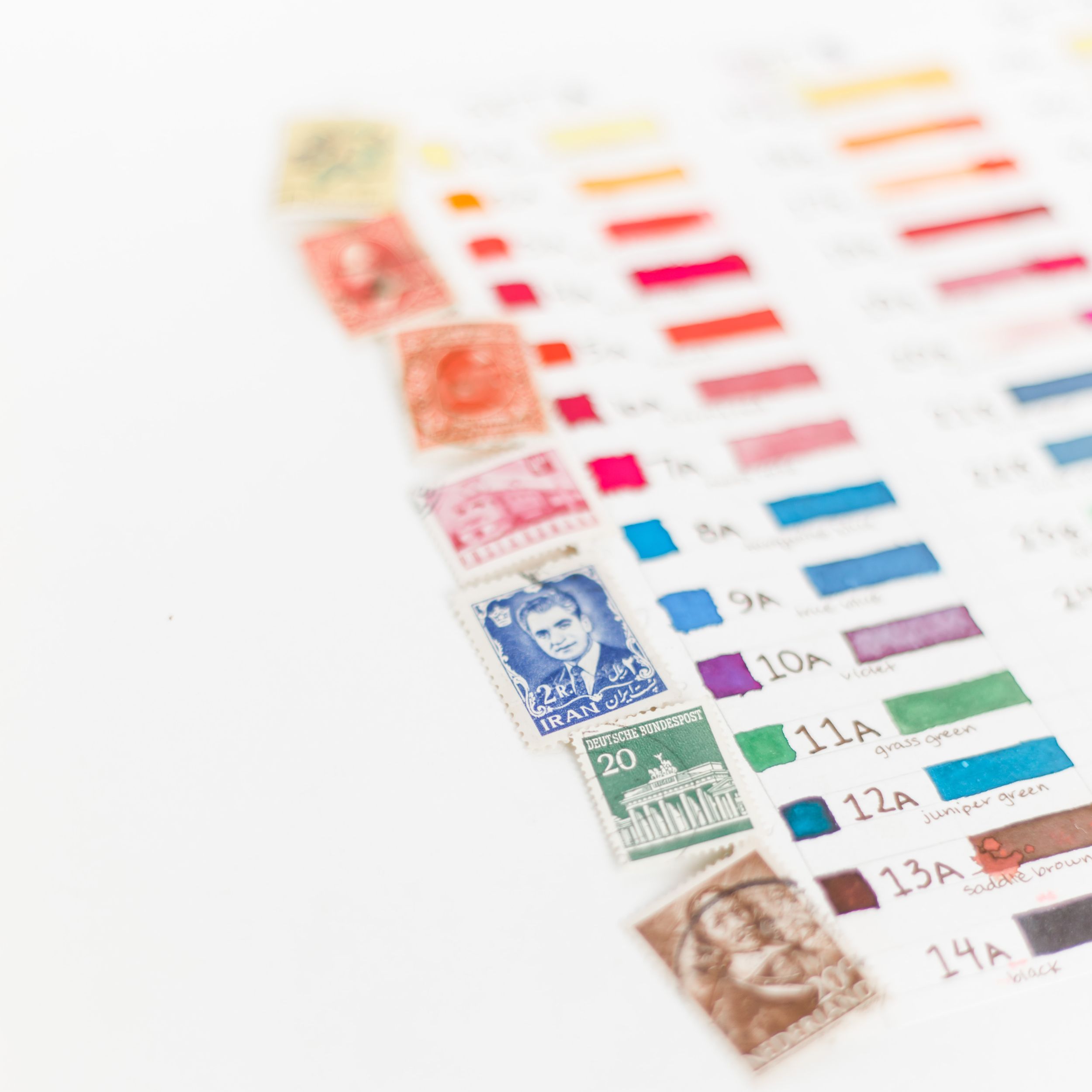 A series of brightly colored stamps lined up alongside a color chart
