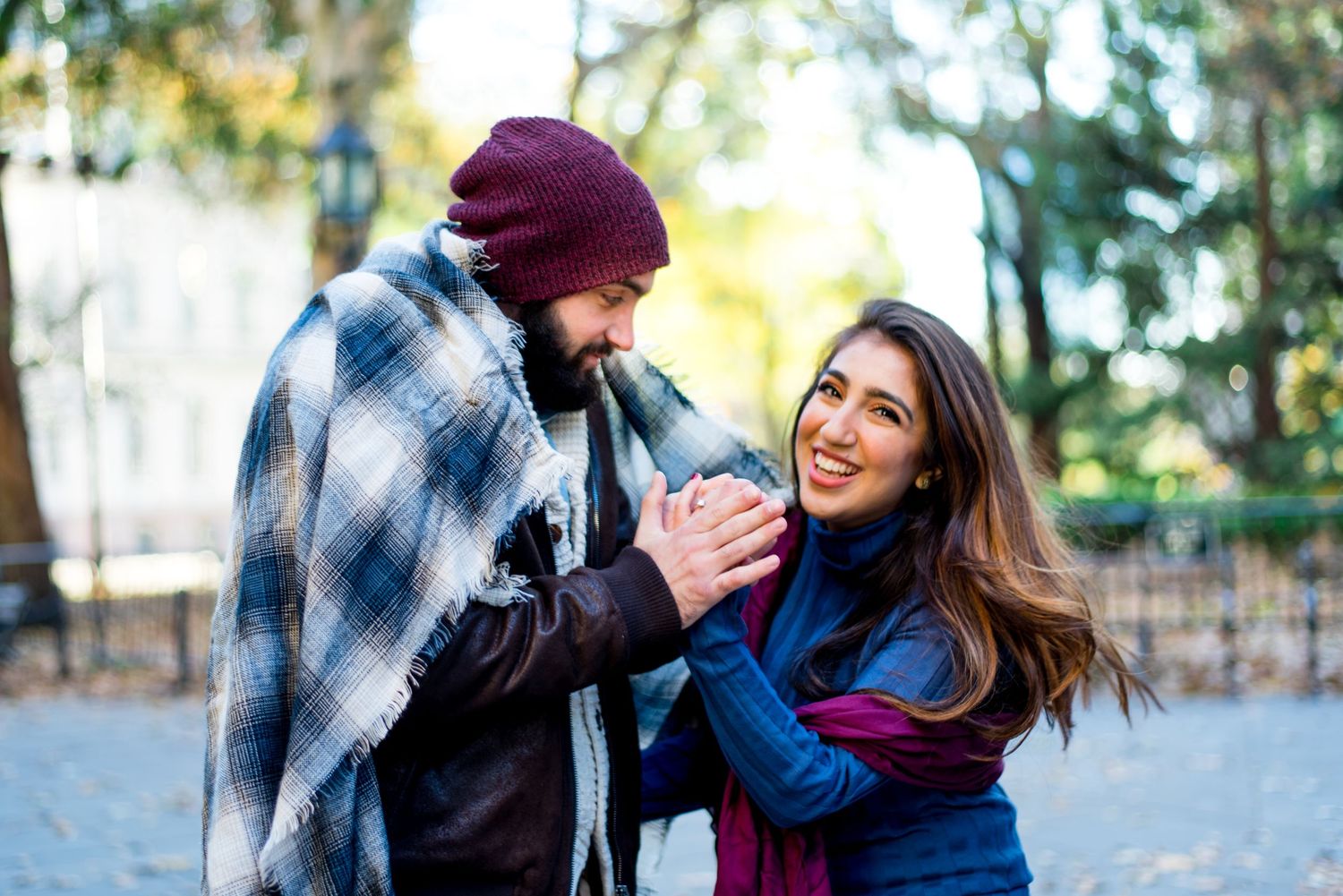 young engaged couples wrapped in a blanket in November for Manhattan Engagement Pictures