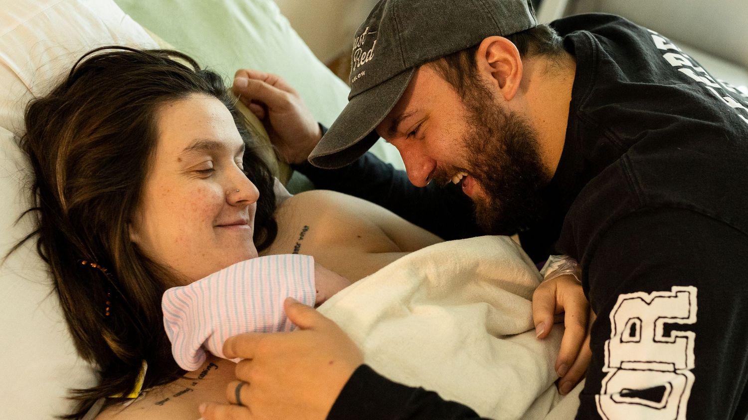 Parents gazing happily at their newborn son moments after his birth