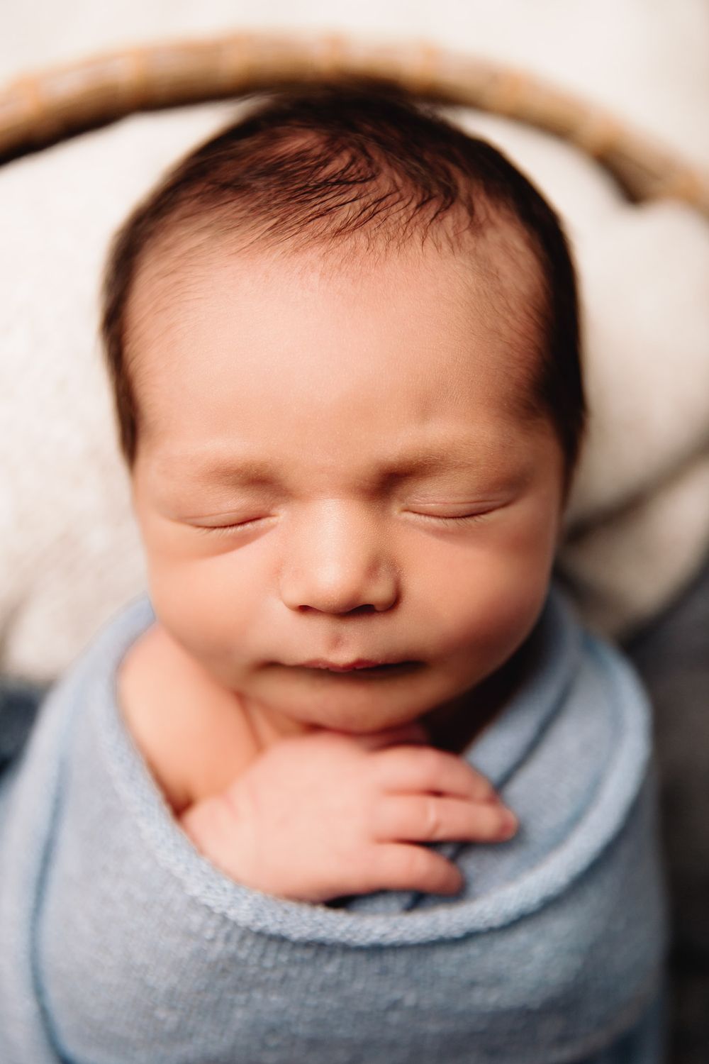 baby boy in blue wrap sleeping during lee's summit newborn photography session
