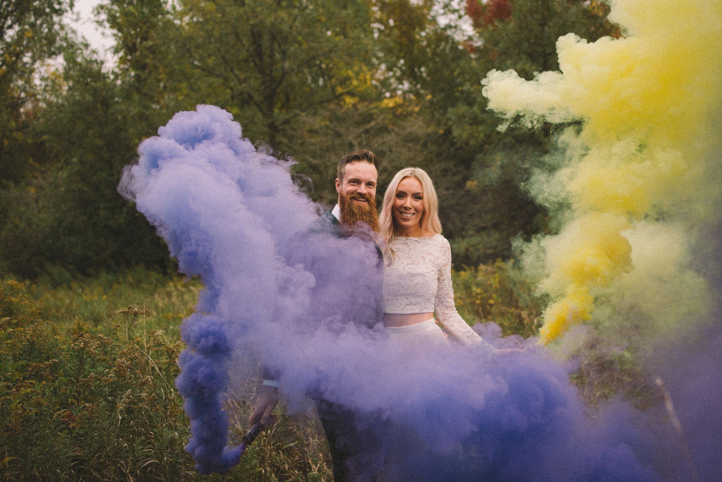 purple and yellow colored smoke bombs wedding