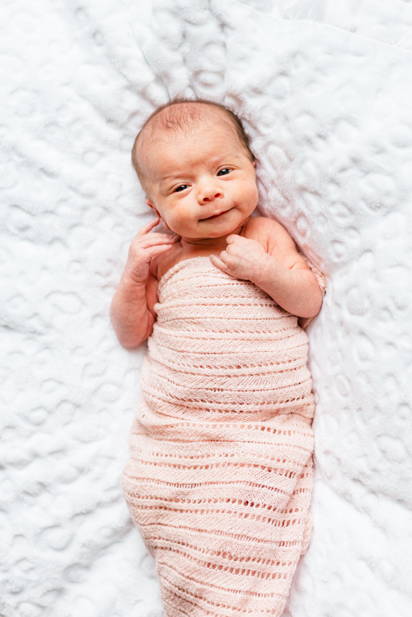 Lifestyle newborn baby in pink wrap in Pittsburgh, Pennsylvania
