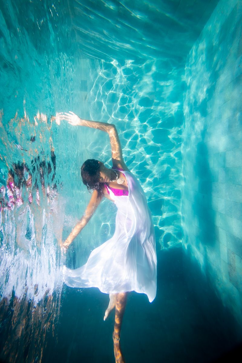 A woman underwater dancing like a ballerina