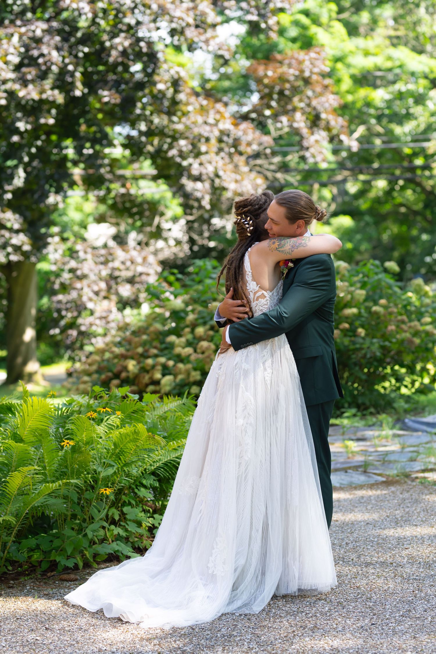A tender moment between newlyweds embracing in a blooming garden setting.