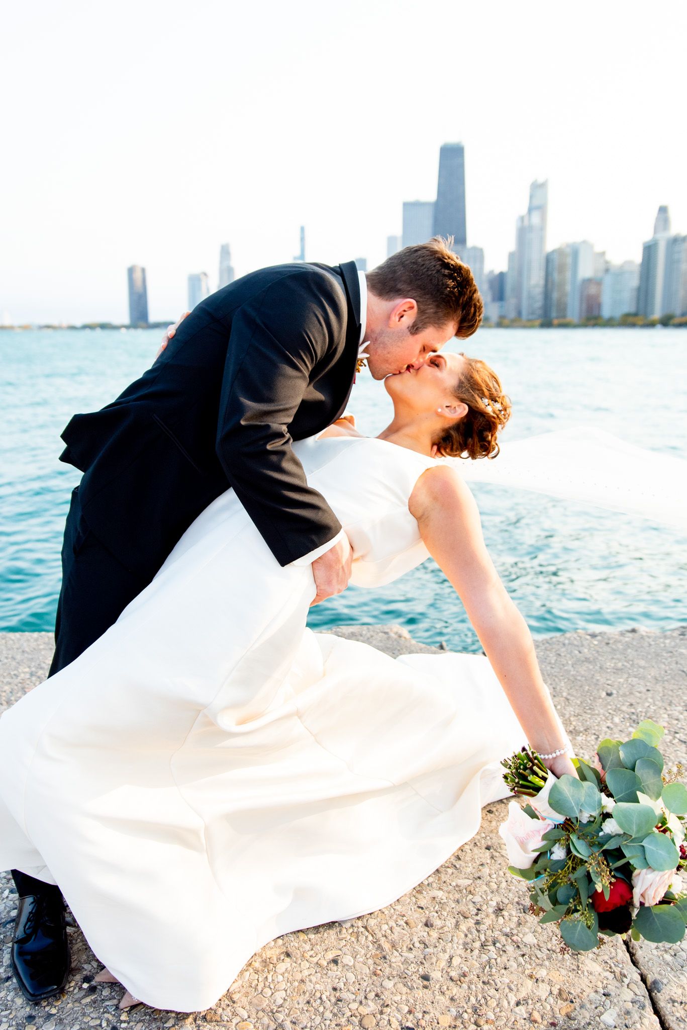groom dances with his wife on north avenue beach pier during october wedding celebration