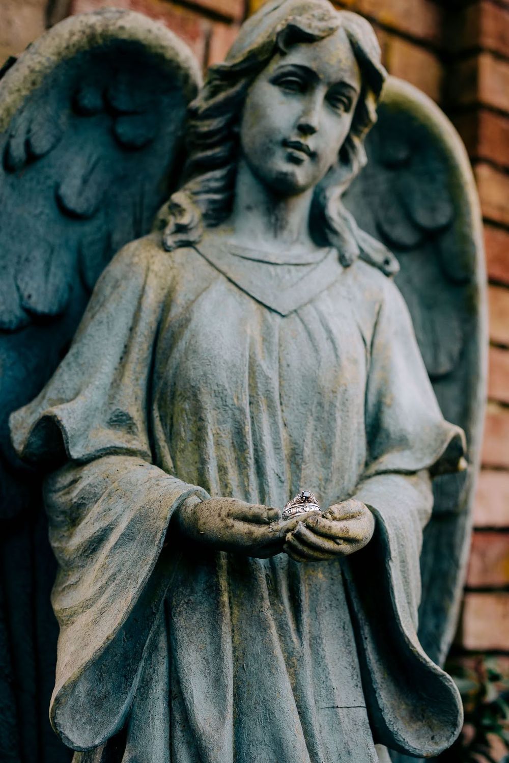 Wedding rings in the hands of an angel Thornewood Castle Lakewood, WA
