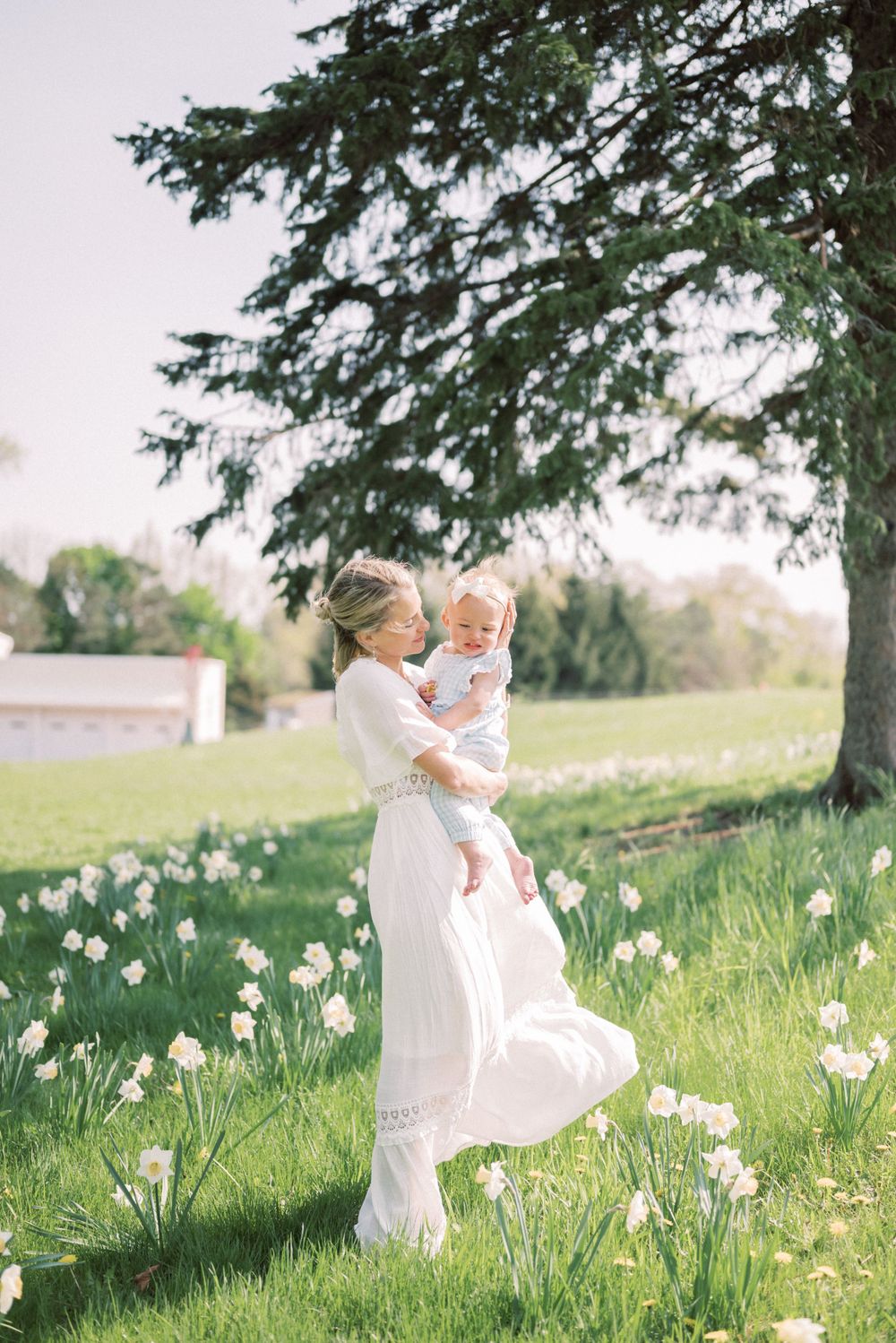 A sweet embrace captured in a blooming spring garden with soft natural lighting.