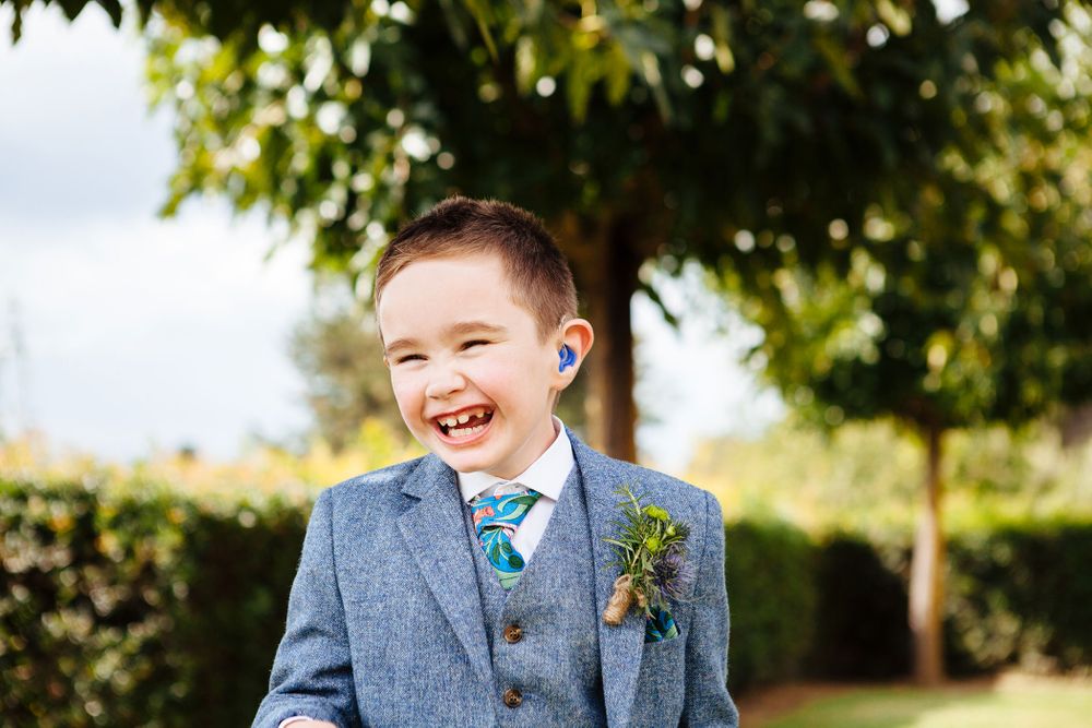 pageboy smiling at destination wedding in Tuscany