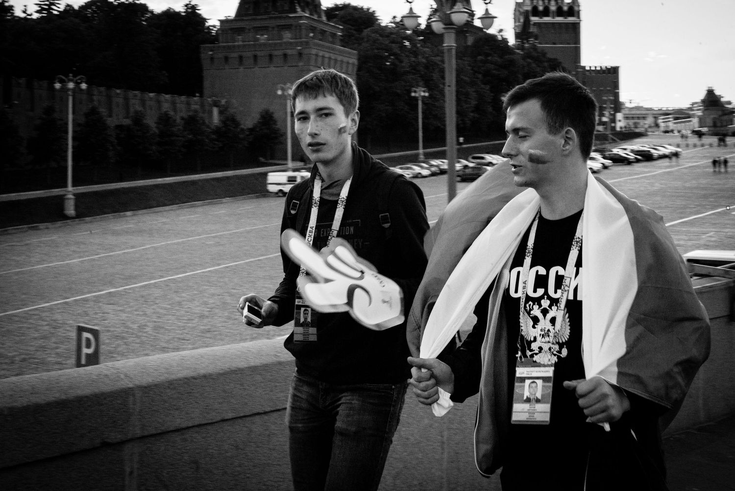 Black and white photo of two football fans crossing the Moskva River in Moscow Russia