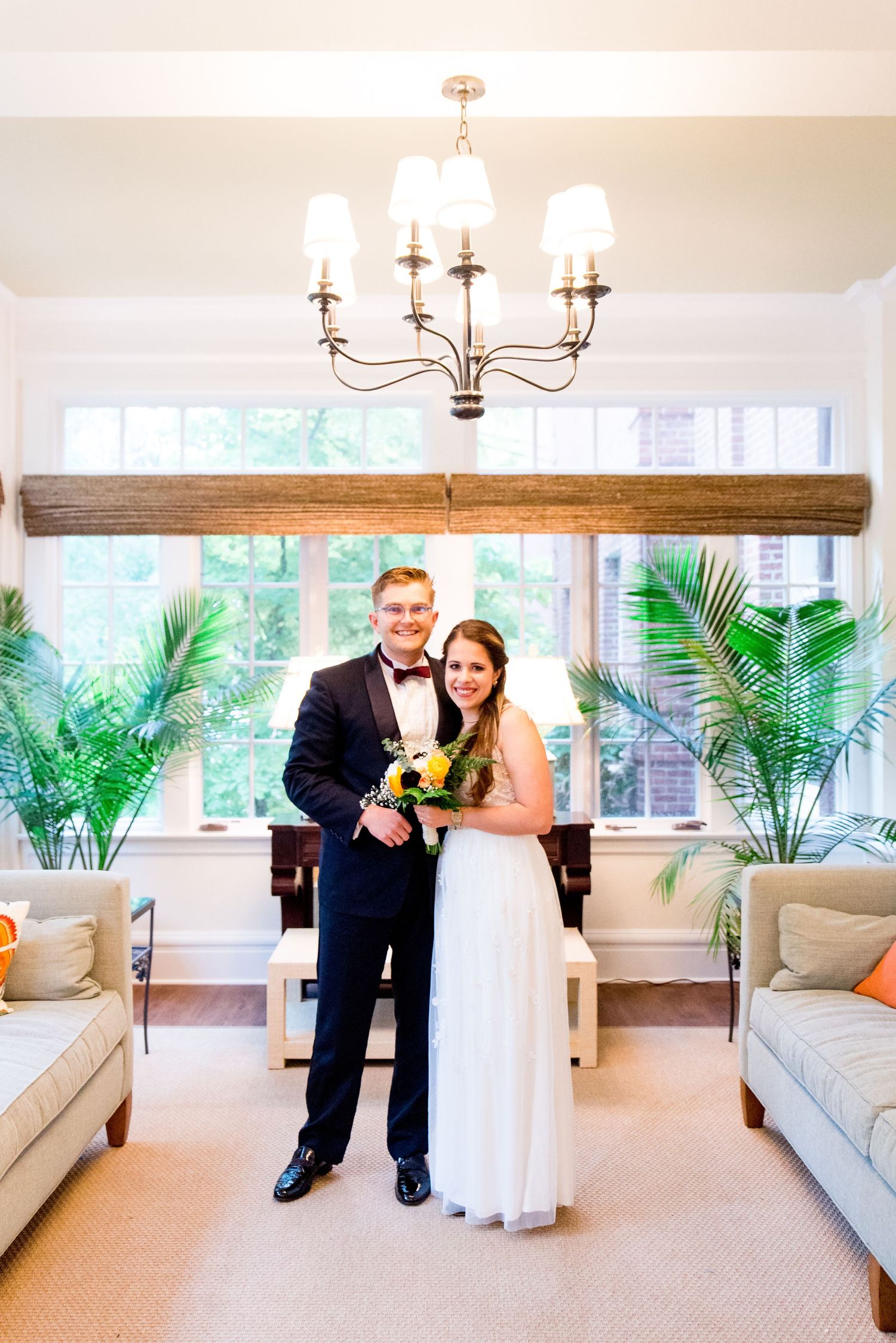 bride and groom hugging in the sunroom at WOman's Club of Evanston on their wedding day