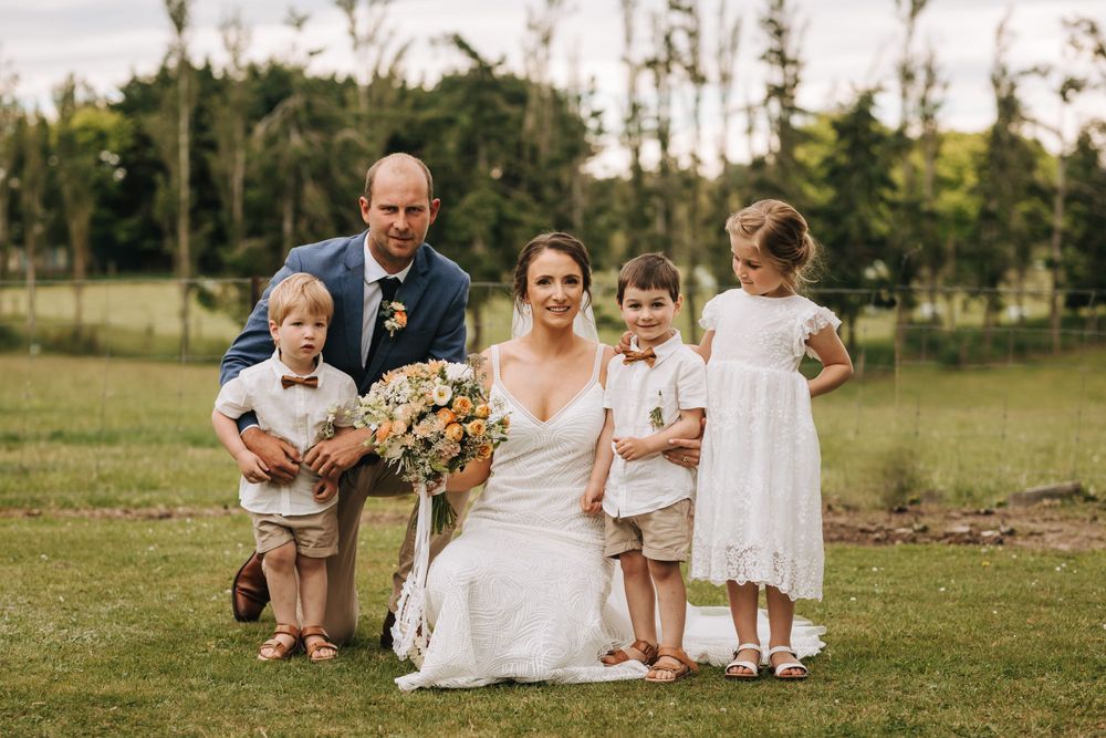 bride and groom with flower girl and page boys