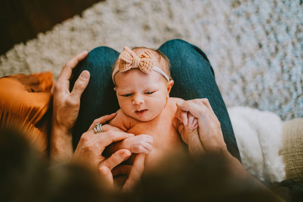 A family poses for a photo during their in-home lifestyle session by Natalie Dyer Photography in Fort Collins, Colorado.