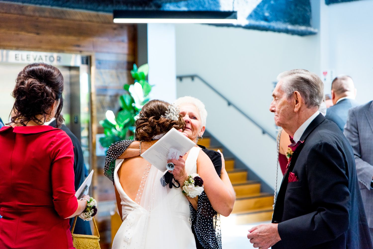 chicago bride hugs wedding guest near stairs after fall chicago wedding