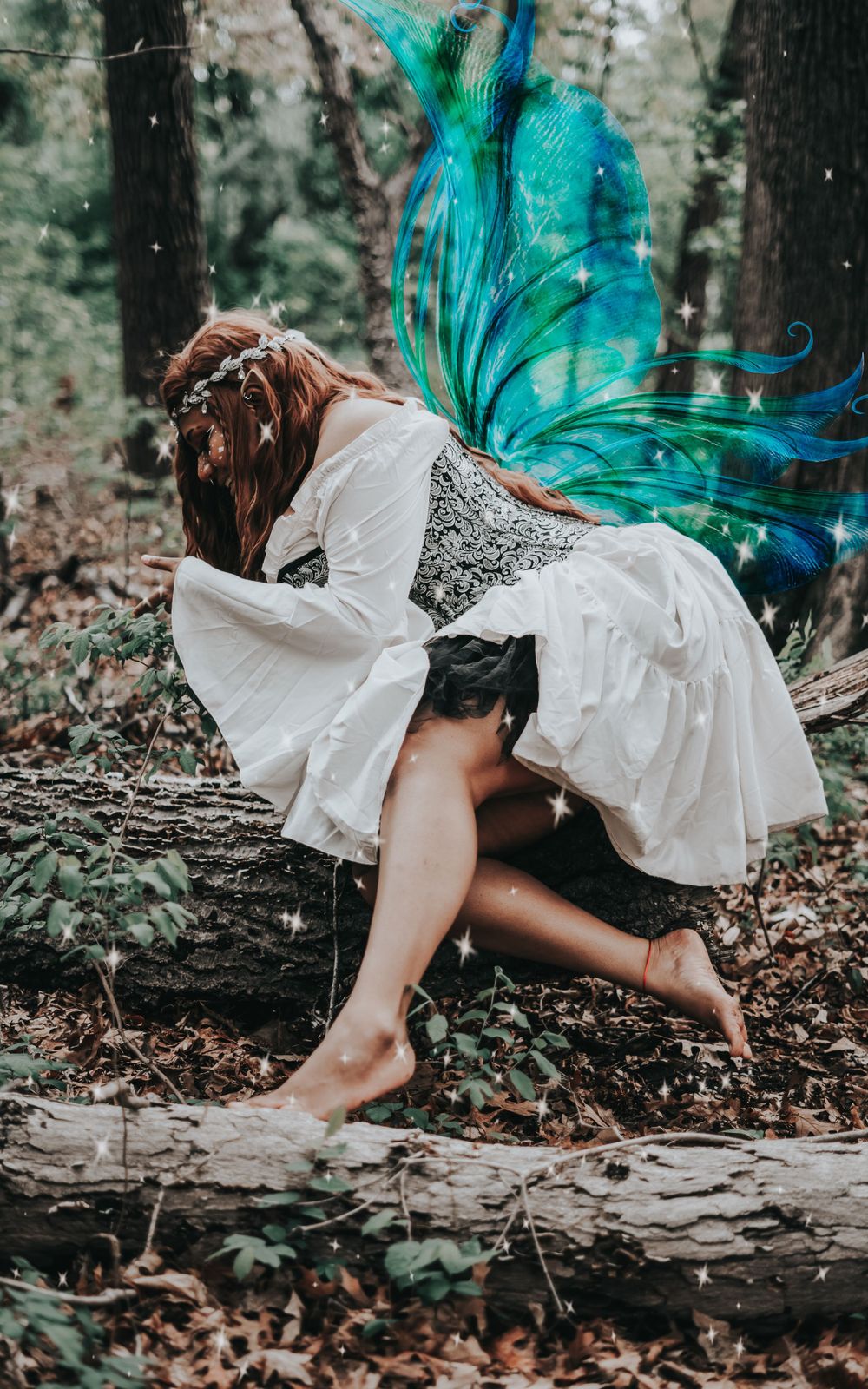 Fae Day Photograph with subject looking down at a plant before them with blue wings