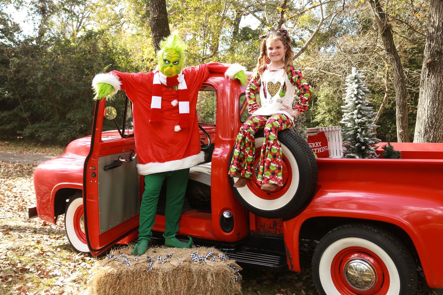 The Grinch and a girl on a red truck by Sassy Massey Photography