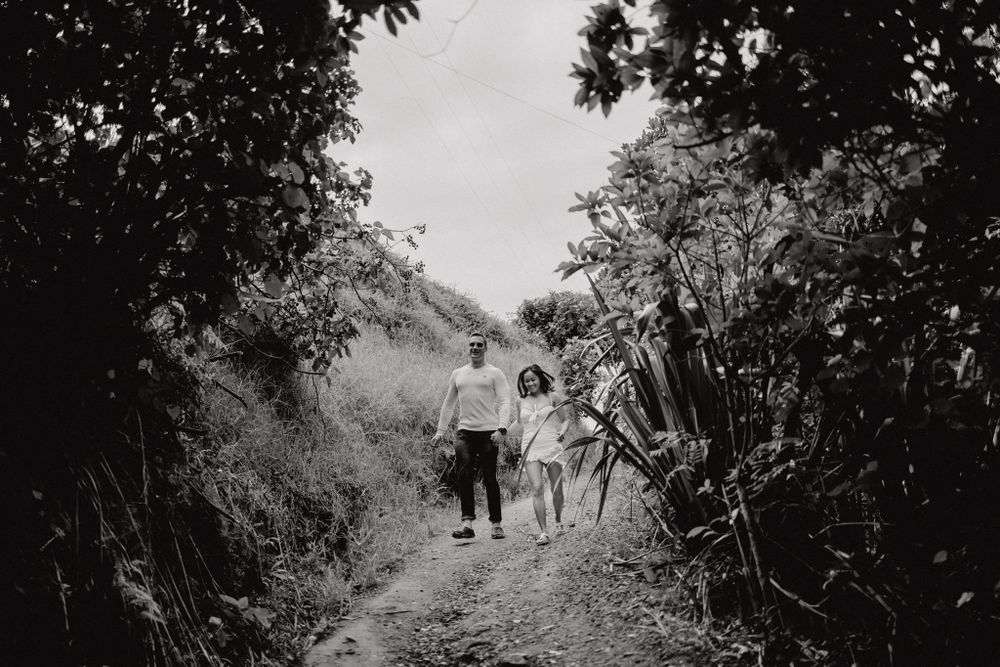 Monochrome shot of couple walking together on scenic mountain trail.