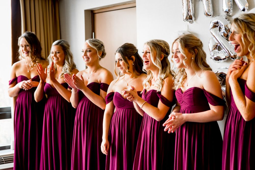 clapping bridesmaids in burgundy excited to see the bride before her chicago wedding