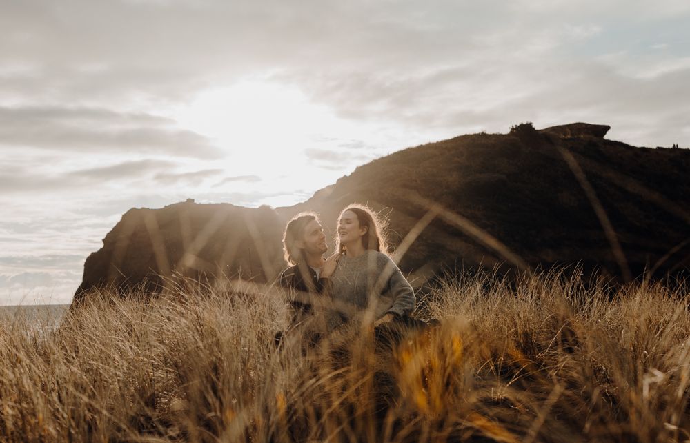 Couple in Piha Beach sunset for their sunset session with Apertured Media-Auckland Wedding and Elopement Photographer