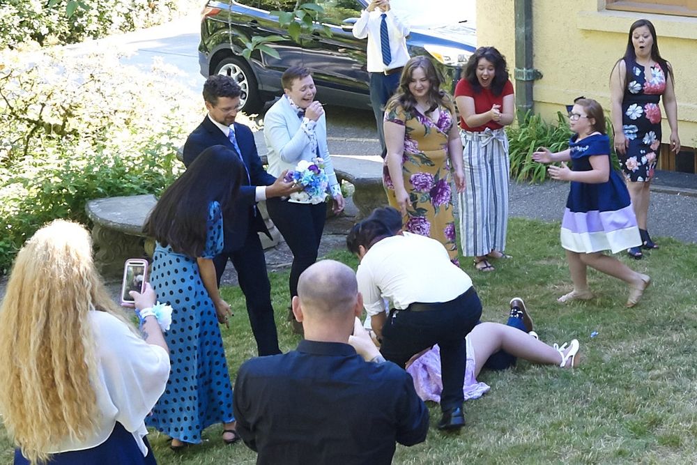 Groomsmen tackles bridesmaid during bouquet toss at Lord Mansion, Olympia, WA