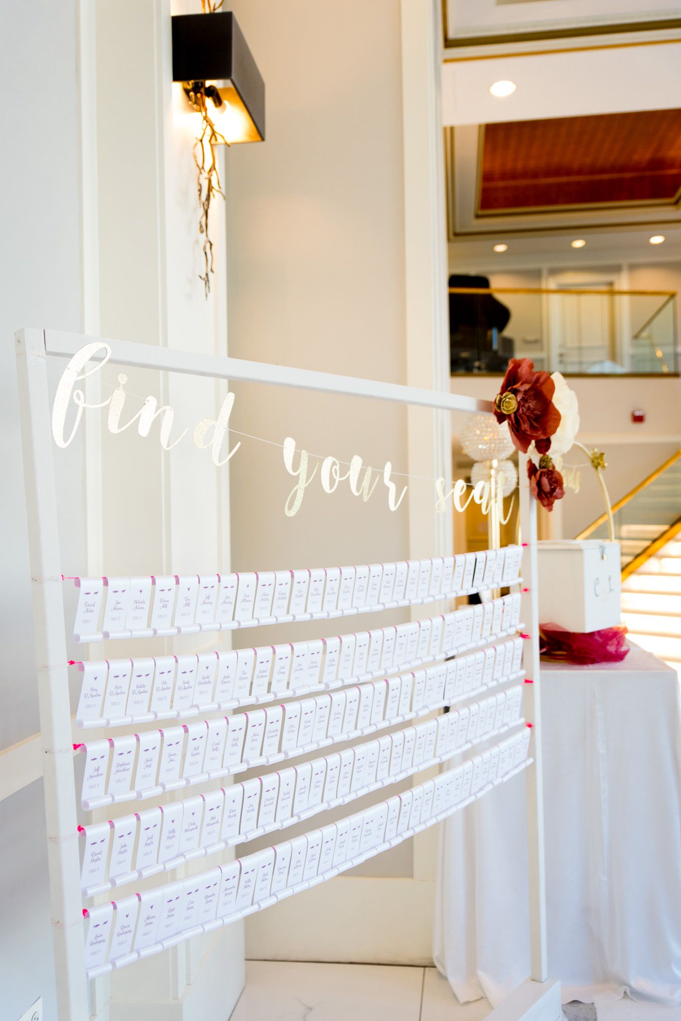maroon and white wedding reception find your seat table assignments at chicago wedding