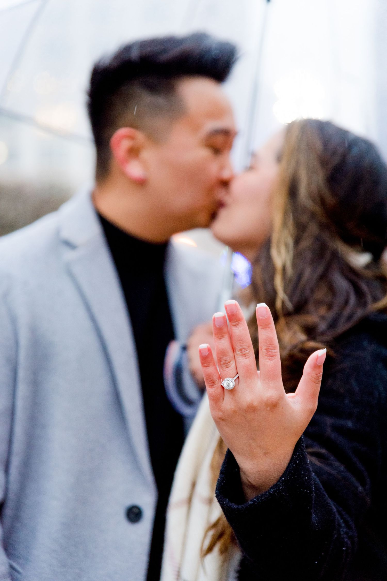 couple kissing in rain after Chicago Proposal