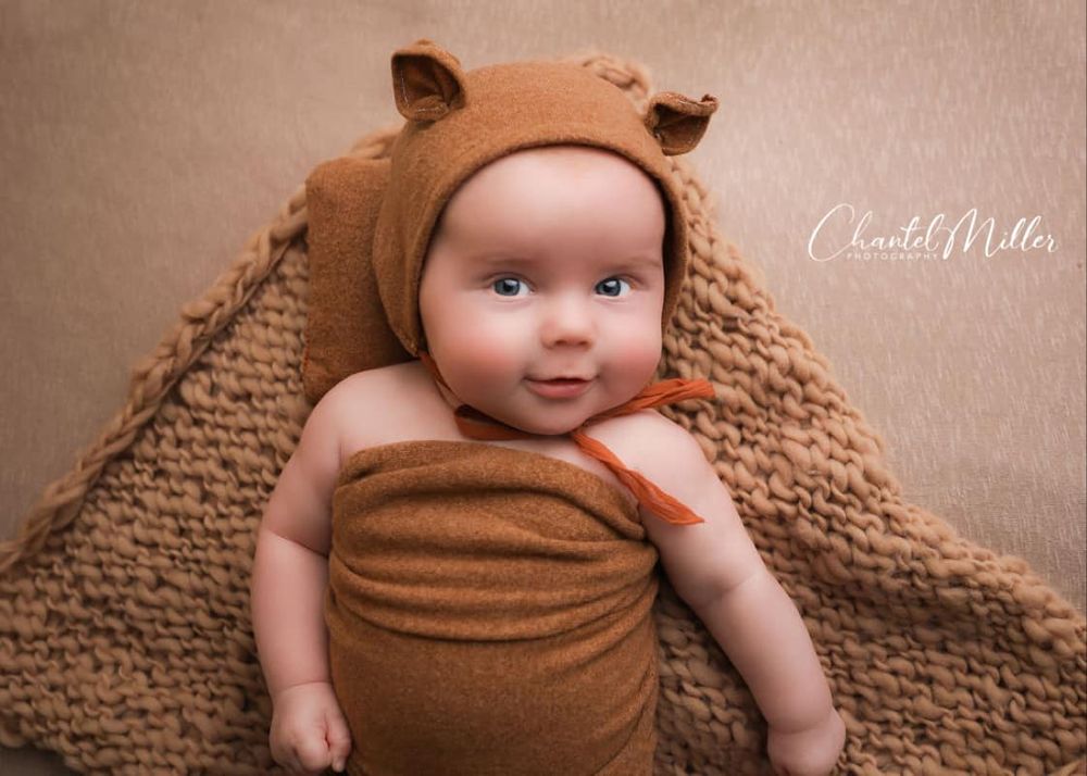 Baby boy dressed as a teddy bear smiling