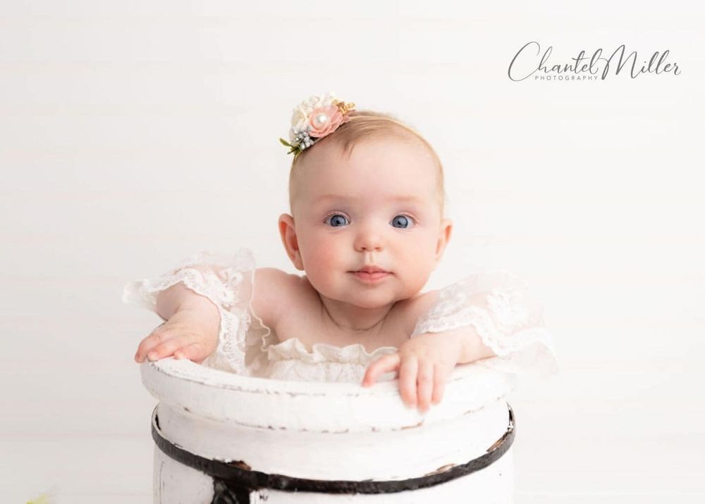 baby girl dressed in white