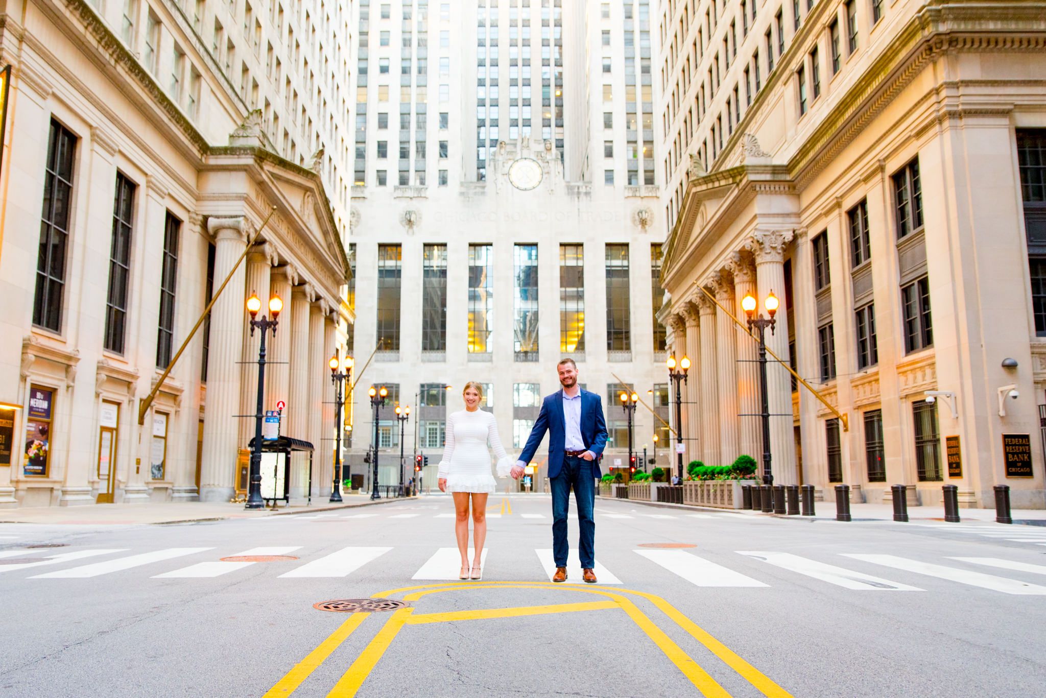 man and woman holding hands in front of Chicago Board of Trade