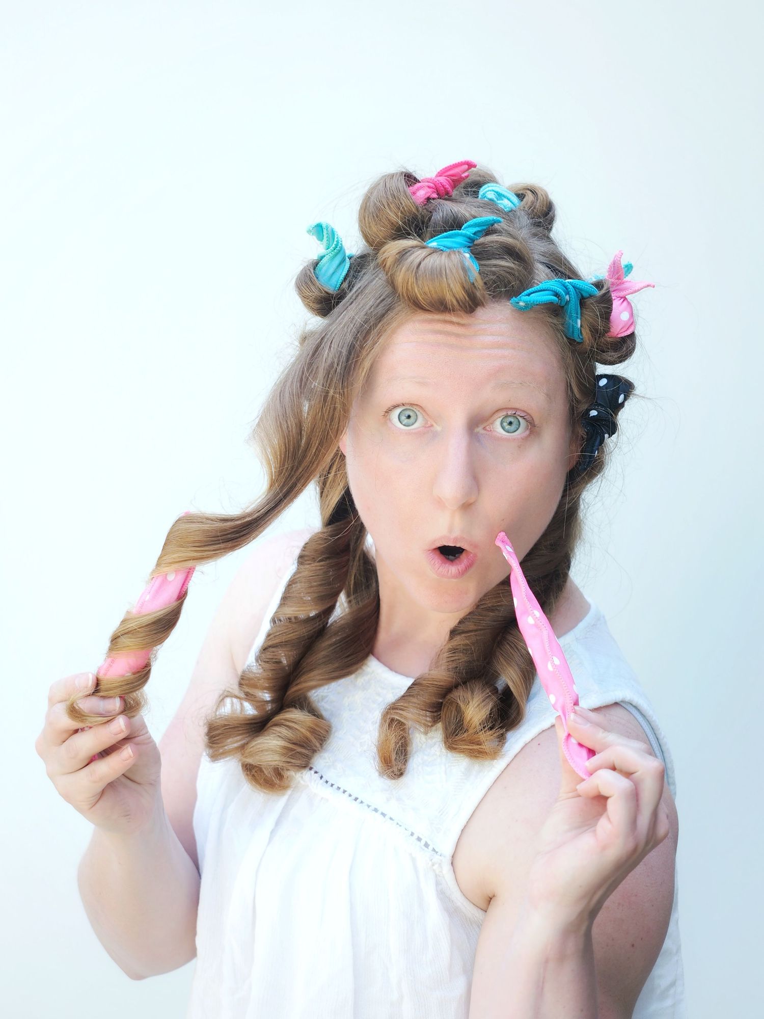 A surprised girl with rollers in her hair