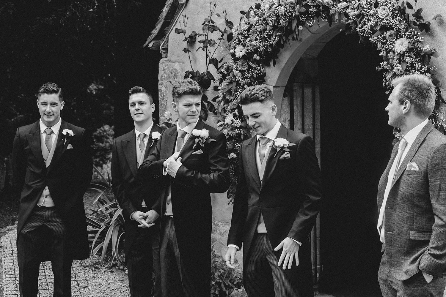 grooms party waiting at the church black and white