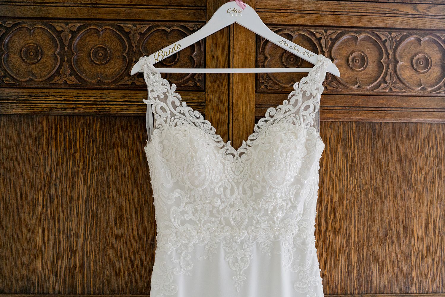 White dress hanging on door