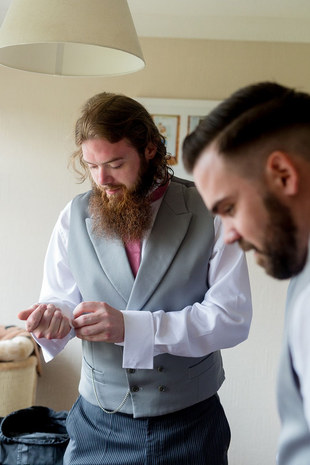 putting on wedding suit