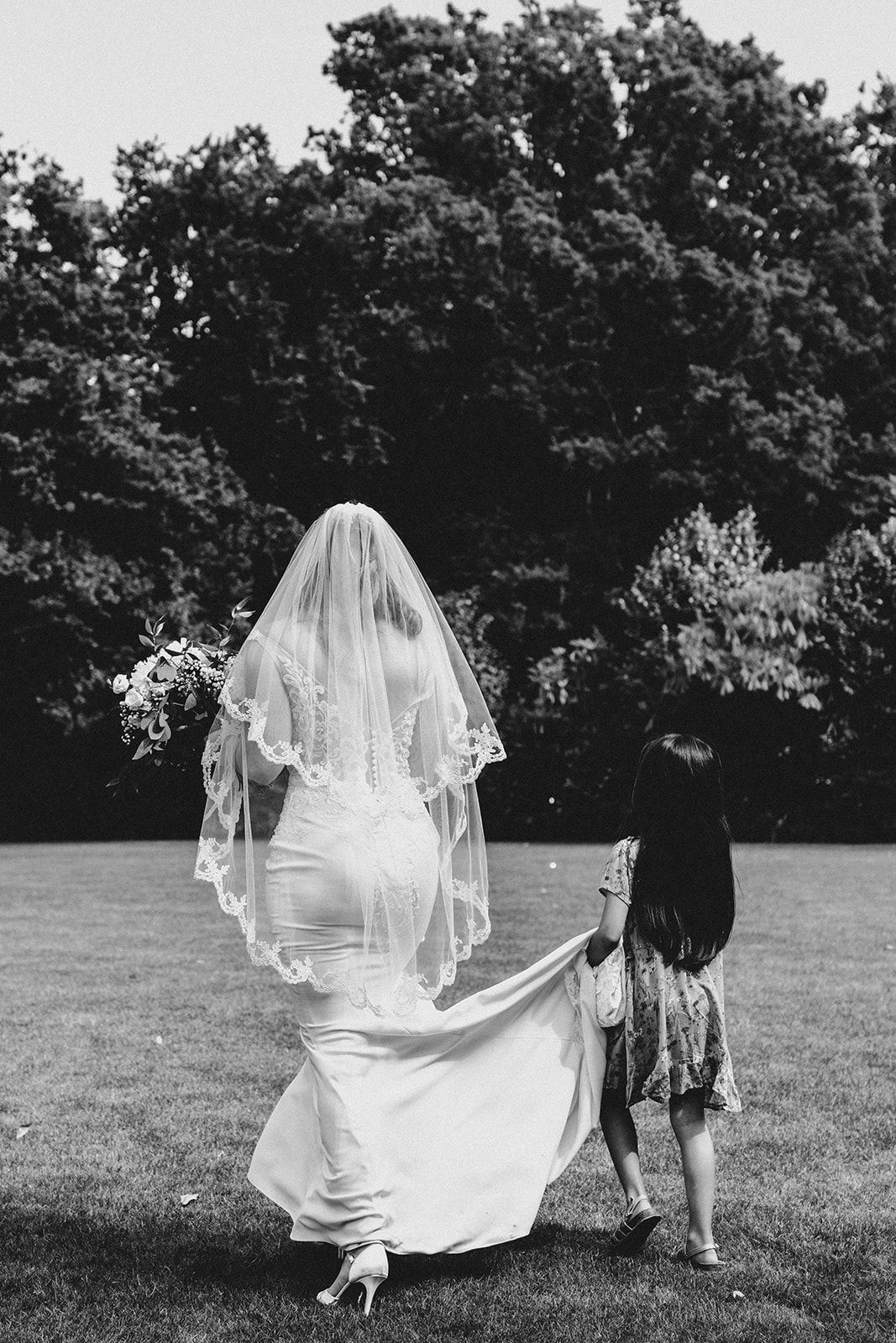 holding the dress children at weddings