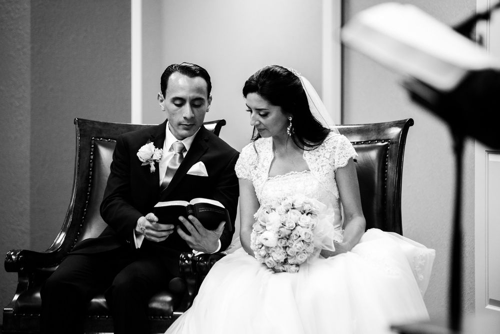 Bride and groom read a scripture during Kingdom Hall wedding ceremony of Jehovah's Witnesses