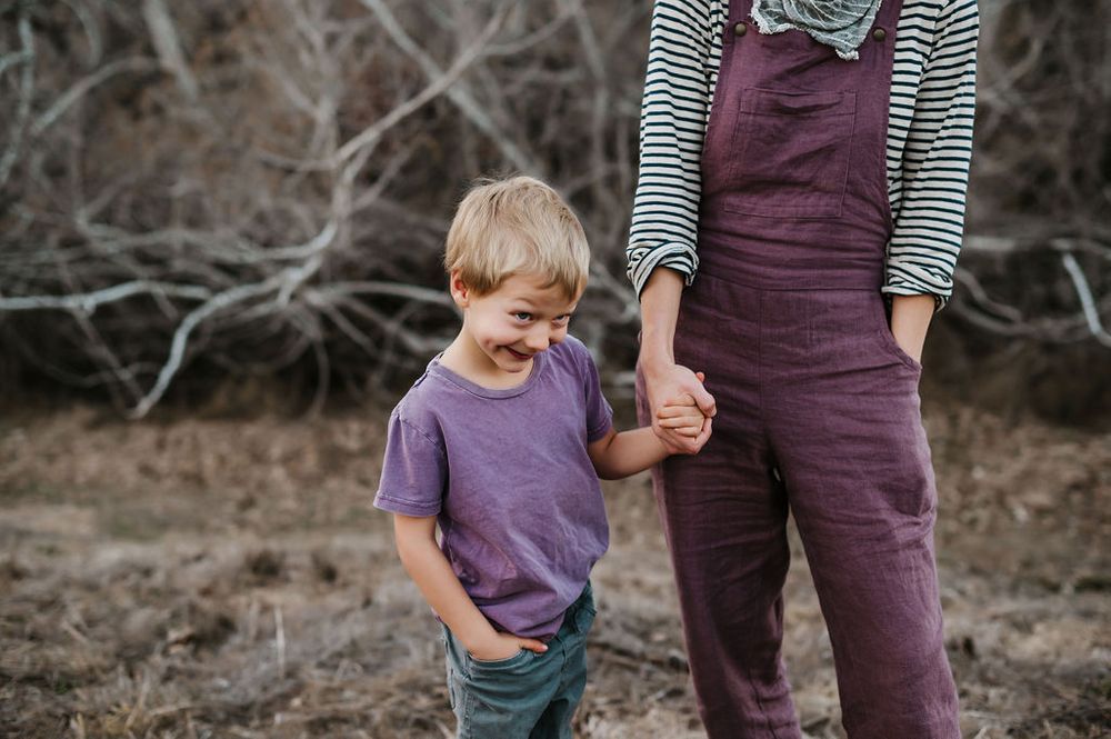 Playful motherhood and son family photography session outdoors on Sonoma County ranch.