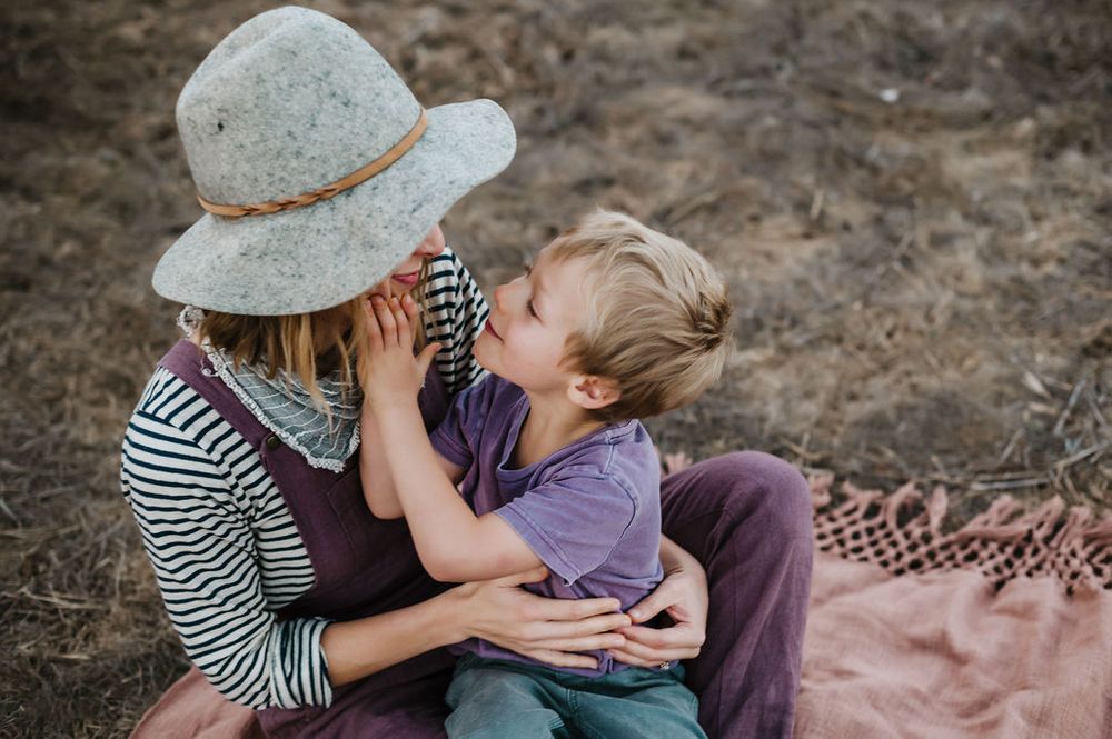 Playful motherhood and son family photography session outdoors on Sonoma County ranch.