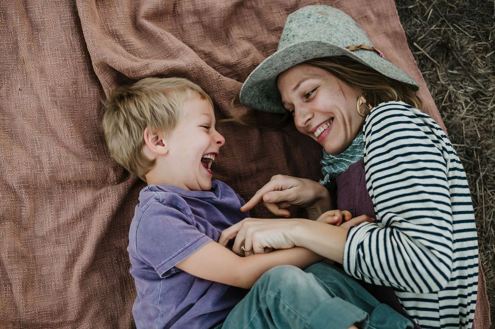 Playful motherhood and son family photography session outdoors on Sonoma County ranch.