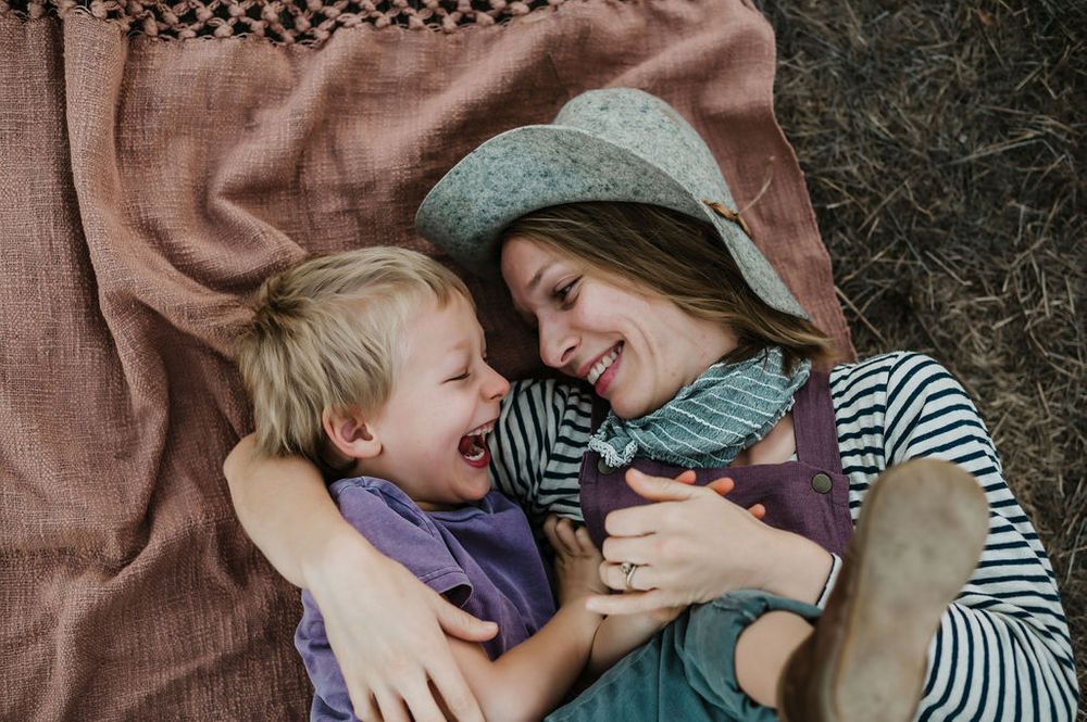 Playful motherhood and son family photography session outdoors on Sonoma County ranch.