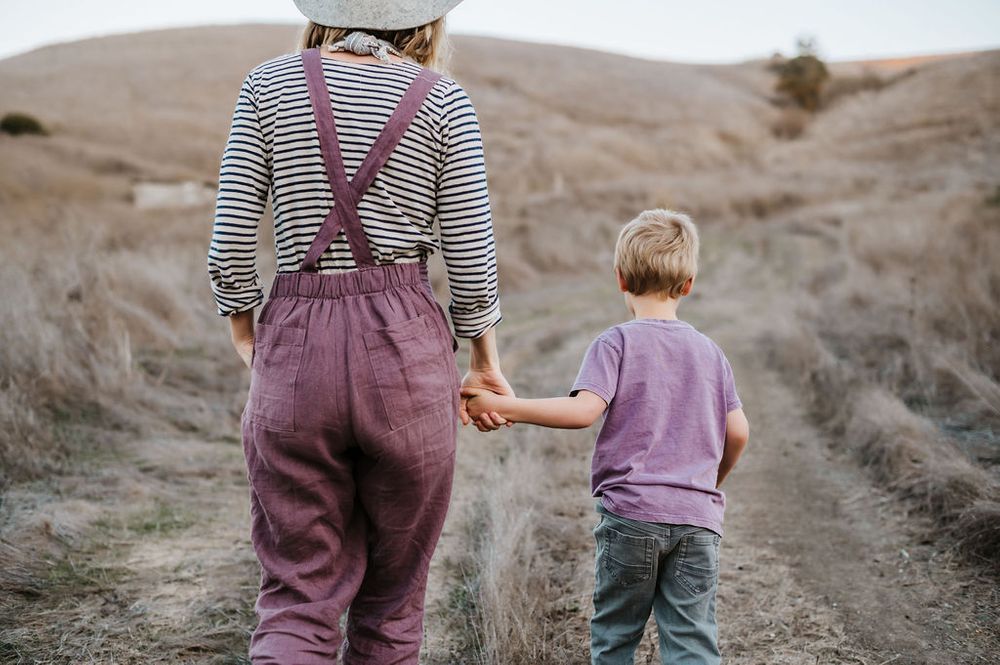 Playful motherhood and son family photography session outdoors on Sonoma County ranch.