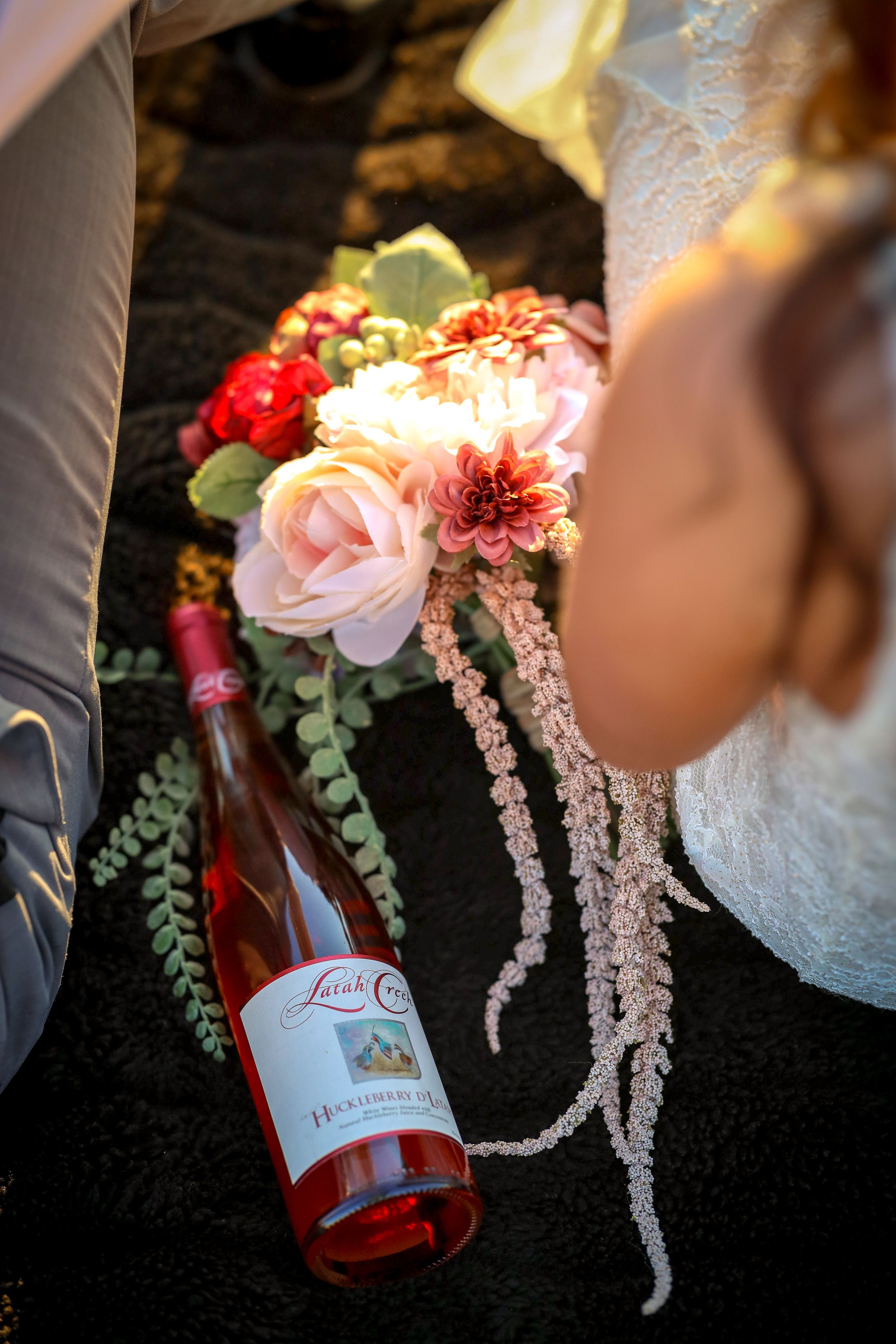 wedding day elopment photo of Wine bottle from Arbor Crest and brides bouqet sitting next to it. Spokane