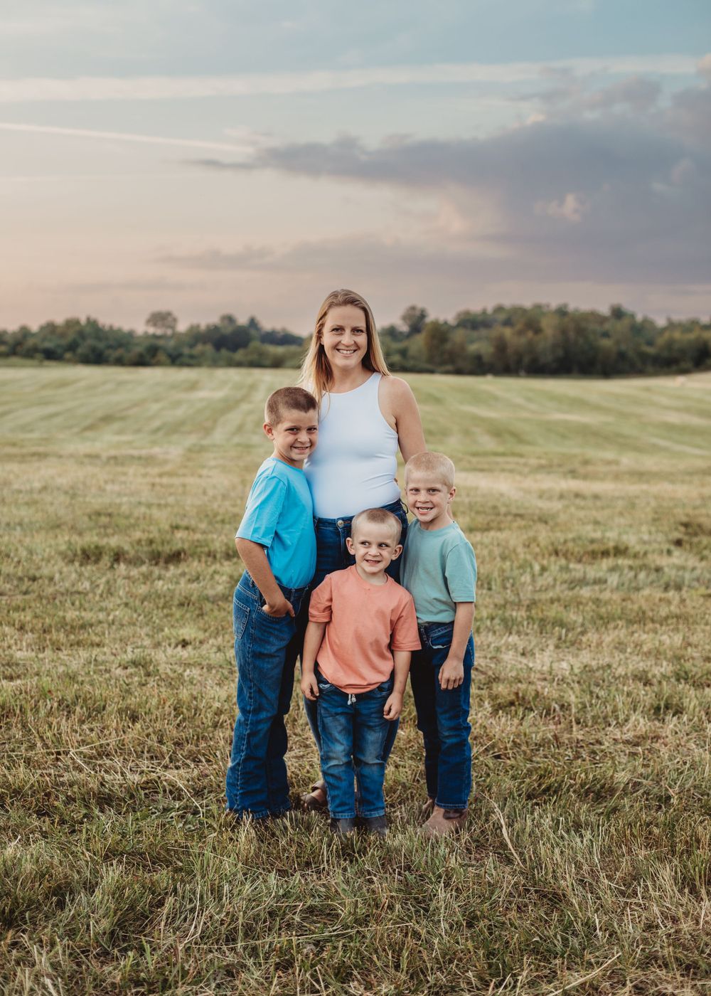Professional photo of a mother and three kids outdoors